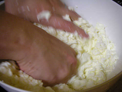 Breaking up the curds and salting